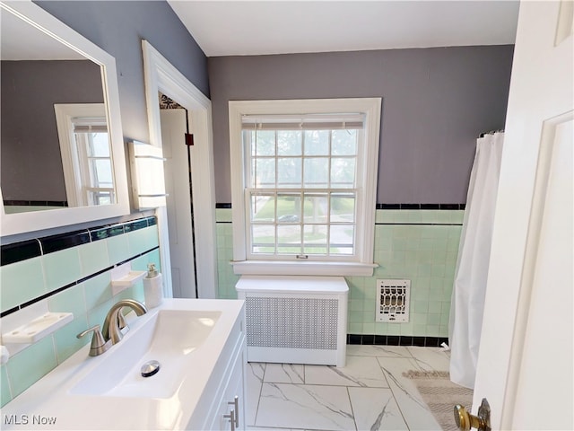 18515 Lomond Blvd, Shaker Heights, OH 44122 - full bath with radiator heating unit, tile walls, heating unit, vanity, and marble finish floors