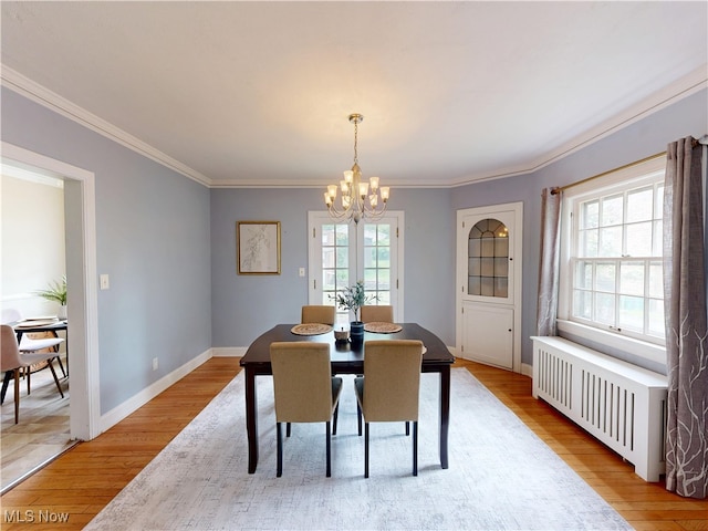 18515 Lomond Blvd, Shaker Heights, OH 44122 - dining area featuring radiator heating unit, a chandelier, light wood finished floors, crown molding, and baseboards