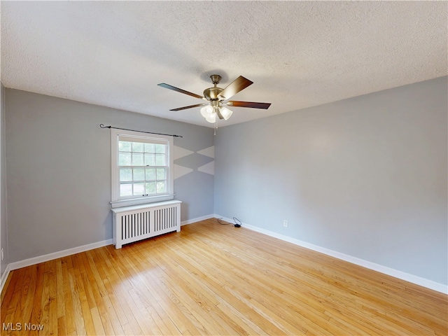 18515 Lomond Blvd, Shaker Heights, OH 44122 - spare room featuring radiator, a textured ceiling, hardwood / wood-style flooring, a ceiling fan, and baseboards