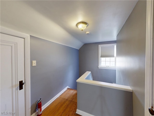 18515 Lomond Blvd, Shaker Heights, OH 44122 - hallway with an upstairs landing, wood finished floors, baseboards, and lofted ceiling