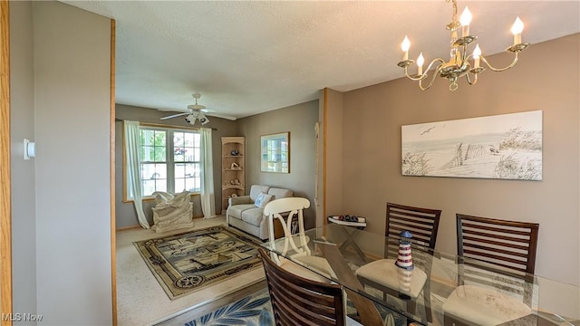 813 Buckeye Ln, Sandusky, OH 44870 - dining room with a chandelier, a ceiling fan, a textured ceiling, carpet flooring, and baseboards