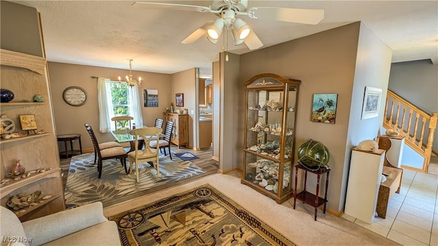 813 Buckeye Ln, Sandusky, OH 44870 - dining space with a chandelier, ceiling fan, baseboards, stairway, and light tile patterned floors