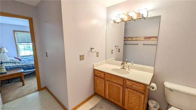 813 Buckeye Ln, Sandusky, OH 44870 - bathroom with vanity, toilet, connected bathroom, and baseboards