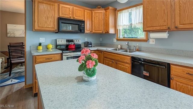 813 Buckeye Ln, Sandusky, OH 44870 - kitchen with black appliances, a sink, and light countertops
