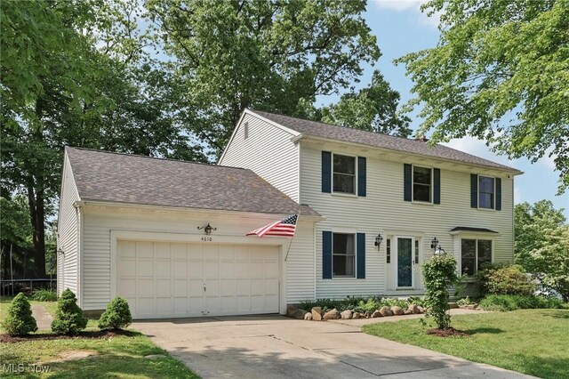 4610 Briarcliff Trl, Copley, OH 44321 - colonial-style house with a garage, concrete driveway, a front lawn, and a shingled roof