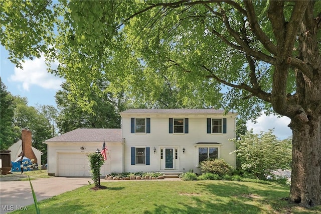 4610 Briarcliff Trl, Copley, OH 44321 - colonial house with concrete driveway, an attached garage, and a front lawn