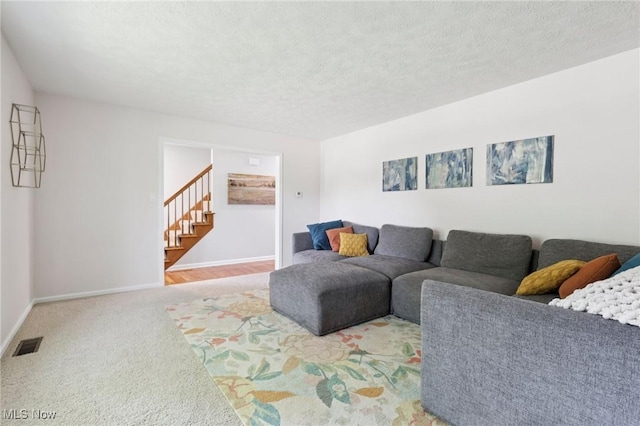 4610 Briarcliff Trl, Copley, OH 44321 - living room with stairs, baseboards, carpet flooring, and a textured ceiling