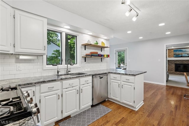 4610 Briarcliff Trl, Copley, OH 44321 - kitchen featuring appliances with stainless steel finishes, a sink, white cabinets, stone counters, and a textured ceiling