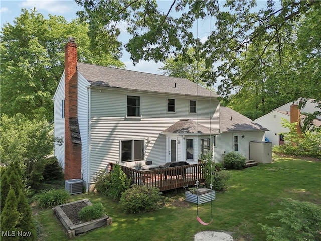4610 Briarcliff Trl, Copley, OH 44321 - rear view of property with a chimney, a lawn, a wooden deck, and cooling unit