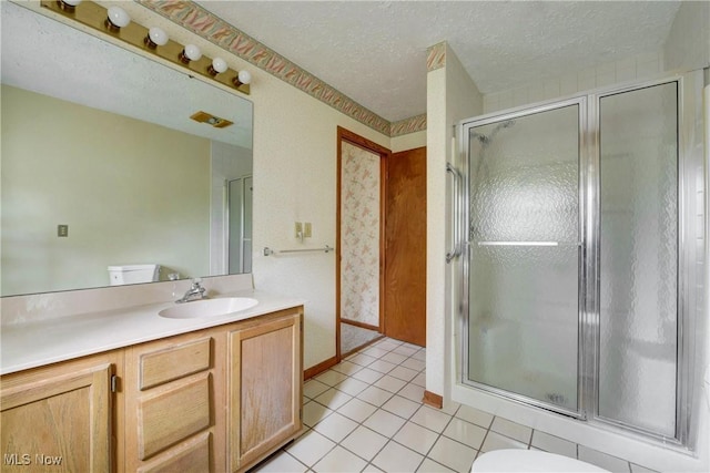 10031 Akins Rd, North Royalton, OH 44133 - bathroom with vanity, a shower stall, a textured ceiling, and tile patterned floors