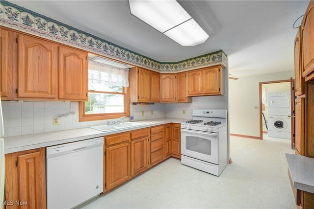10031 Akins Rd, North Royalton, OH 44133 - kitchen featuring white appliances, stacked washer and clothes dryer, decorative backsplash, and light countertops