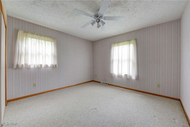 10031 Akins Rd, North Royalton, OH 44133 - unfurnished room featuring carpet, a textured ceiling, a ceiling fan, and wallpapered walls