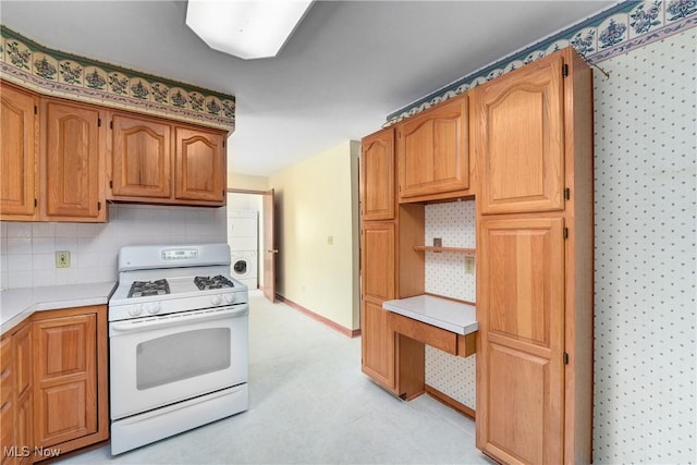 10031 Akins Rd, North Royalton, OH 44133 - kitchen featuring white gas stove, light countertops, open shelves, tasteful backsplash, and brown cabinetry