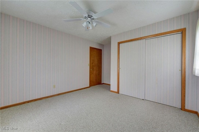 10031 Akins Rd, North Royalton, OH 44133 - unfurnished bedroom featuring wallpapered walls, carpet, a closet, ceiling fan, and a textured ceiling