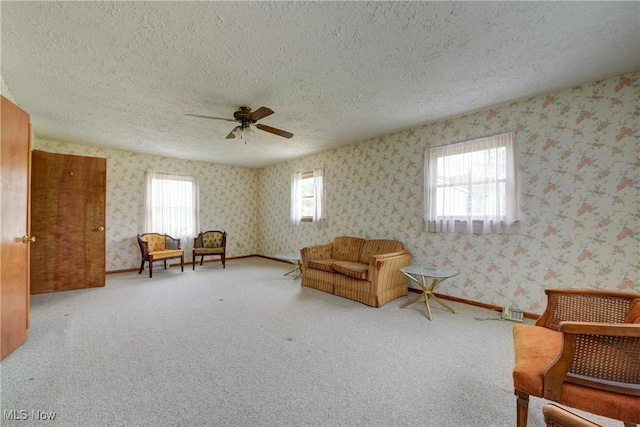 10031 Akins Rd, North Royalton, OH 44133 - living area with a textured ceiling, a ceiling fan, wallpapered walls, and carpet flooring
