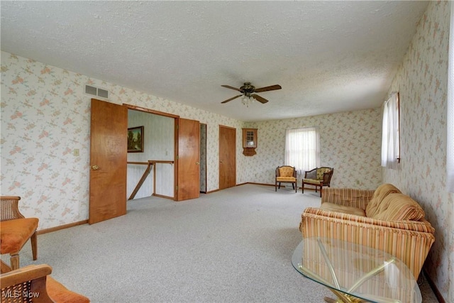 10031 Akins Rd, North Royalton, OH 44133 - sitting room featuring wallpapered walls, a ceiling fan, a textured ceiling, an upstairs landing, and carpet floors