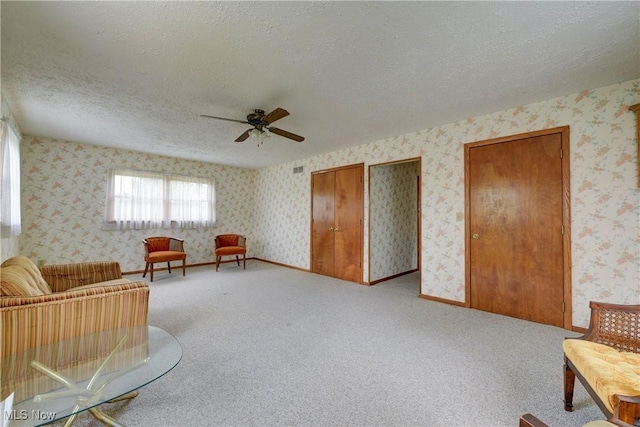 10031 Akins Rd, North Royalton, OH 44133 - sitting room featuring a textured ceiling, a ceiling fan, wallpapered walls, and light carpet