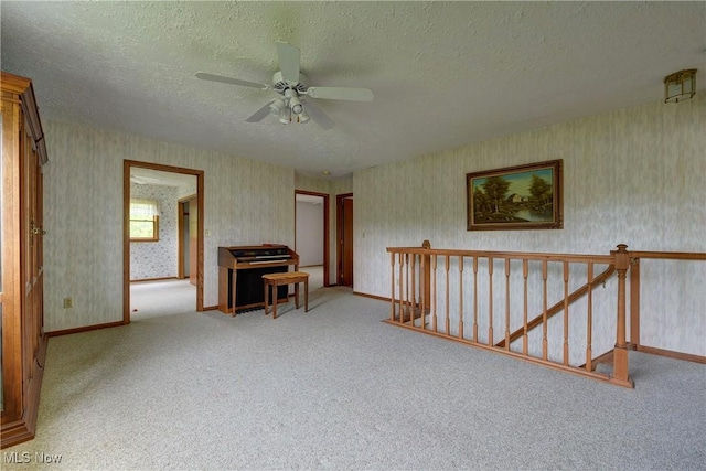 10031 Akins Rd, North Royalton, OH 44133 - empty room featuring wallpapered walls, ceiling fan, a textured ceiling, and carpet flooring