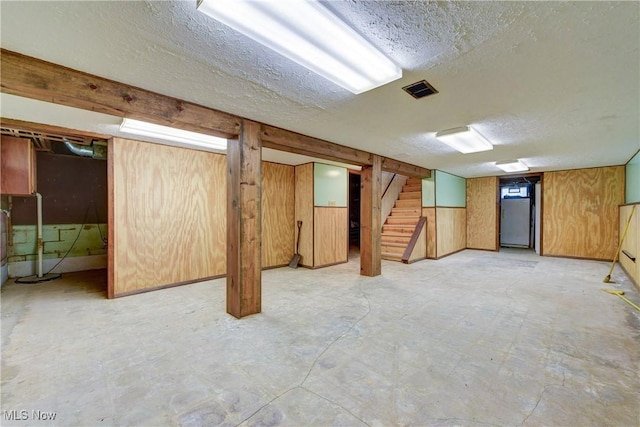 10031 Akins Rd, North Royalton, OH 44133 - finished basement featuring a textured ceiling, stairway, and wooden walls