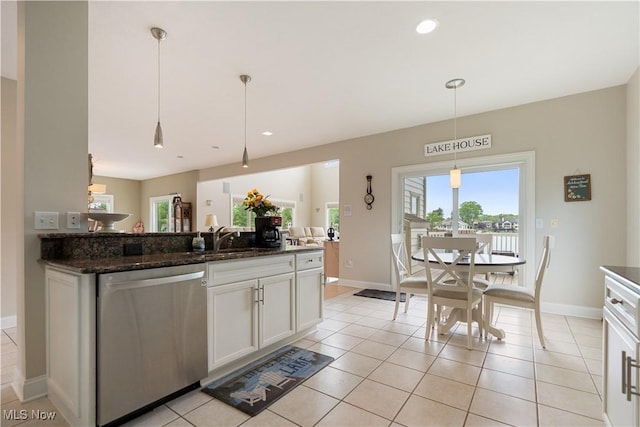 5325 S Island Dr NW, Canton, OH 44718 - kitchen featuring stainless steel dishwasher, white cabinetry, pendant lighting, dark stone counters, and baseboards