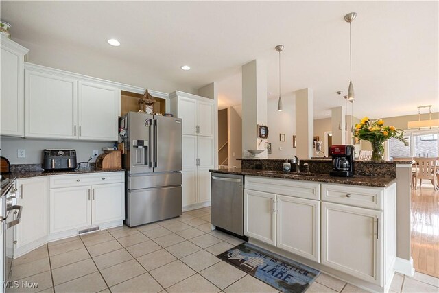 5325 S Island Dr NW, Canton, OH 44718 - kitchen with appliances with stainless steel finishes, a sink, white cabinetry, hanging light fixtures, and recessed lighting