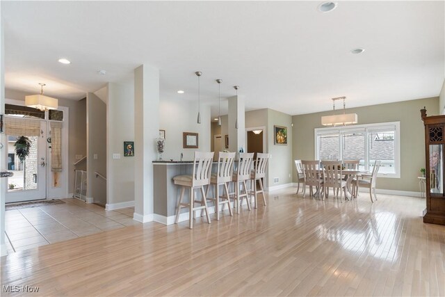 5325 S Island Dr NW, Canton, OH 44718 - kitchen with light wood-style floors, baseboards, recessed lighting, and hanging light fixtures