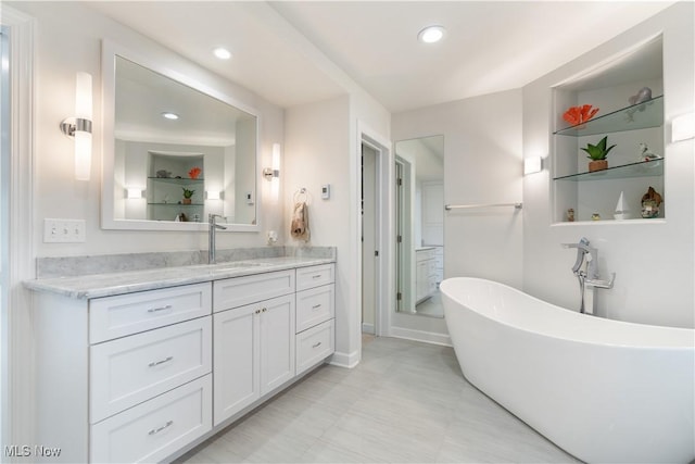 5325 S Island Dr NW, Canton, OH 44718 - bathroom featuring a freestanding bath, vanity, recessed lighting, and baseboards