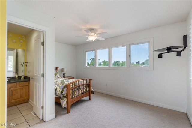 5325 S Island Dr NW, Canton, OH 44718 - bedroom with baseboards, connected bathroom, a sink, and light colored carpet