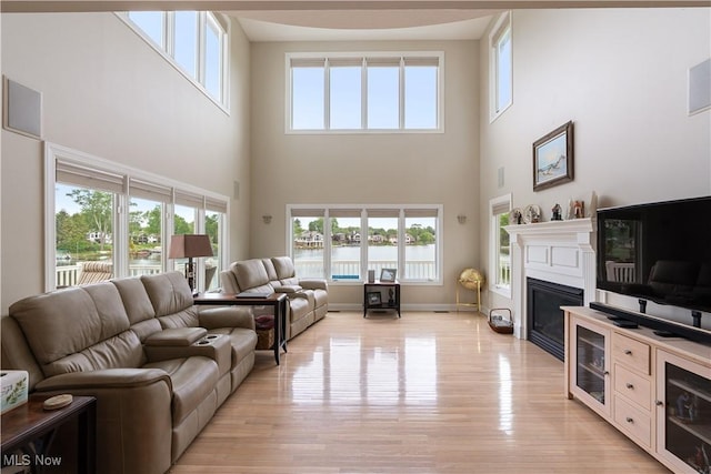 5325 S Island Dr NW, Canton, OH 44718 - living area featuring a towering ceiling, healthy amount of natural light, light wood-style floors, and a fireplace