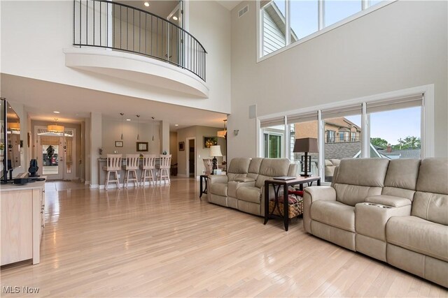 5325 S Island Dr NW, Canton, OH 44718 - living area featuring a high ceiling, light wood-style floors, and healthy amount of natural light