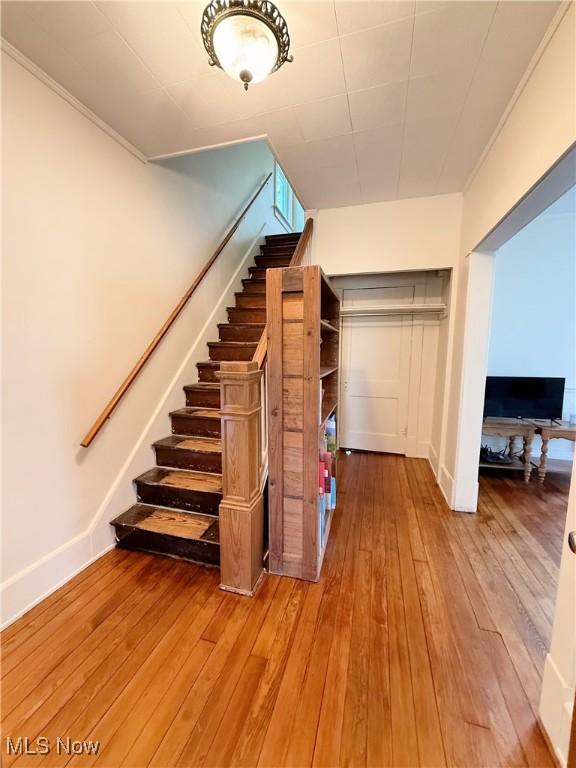 249 S 15th St, Sebring, OH 44672 - stairs with hardwood / wood-style flooring, baseboards, and crown molding