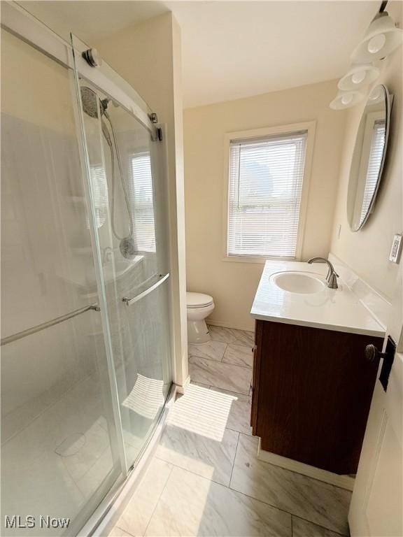249 S 15th St, Sebring, OH 44672 - bathroom with vanity, toilet, healthy amount of natural light, and a stall shower