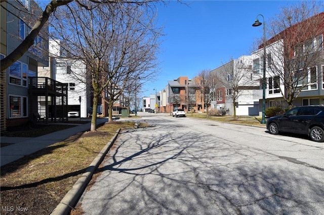 1261 W 74, Cleveland, OH 44102 - view of asphalt street featuring a residential view, curbs, and street lights