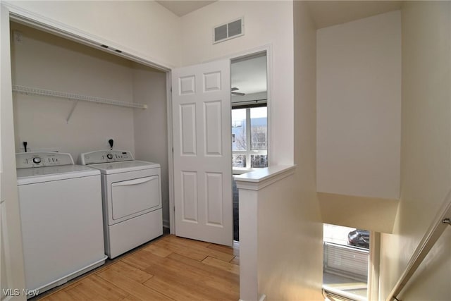 1261 W 74, Cleveland, OH 44102 - washroom featuring separate washer and dryer and light wood finished floors