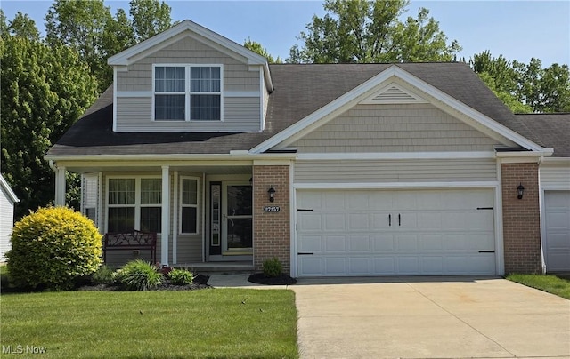 27257 Emerald Oval S, Oh, OH 44138 - view of front of home featuring brick siding, driveway, covered porch, and an attached garage