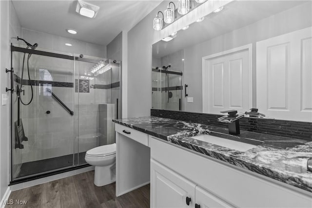 4004 Coventry Ln, Huron, OH 44839 - full bath featuring vanity, toilet, wood finished floors, and a stall shower