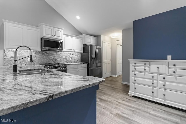 4004 Coventry Ln, Huron, OH 44839 - kitchen with appliances with stainless steel finishes, a sink, light stone counters, tasteful backsplash, and white cabinets