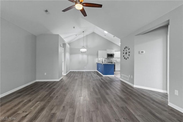4004 Coventry Ln, Huron, OH 44839 - unfurnished living room featuring ceiling fan, dark wood-style flooring, a sink, vaulted ceiling, and baseboards