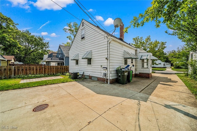 23701 Colbourne Rd, Euclid, OH 44123 - view of side of property featuring a chimney, central air condition unit, and a patio
