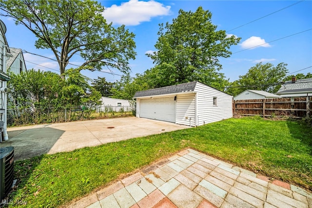 23701 Colbourne Rd, Euclid, OH 44123 - view of yard featuring an outbuilding, a garage, a patio, and central AC