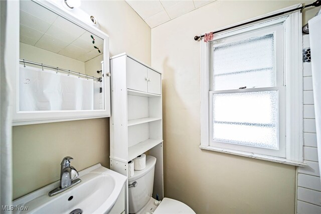 23701 Colbourne Rd, Euclid, OH 44123 - bathroom with a sink, toilet, and a shower with shower curtain
