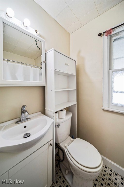 23701 Colbourne Rd, Euclid, OH 44123 - full bathroom with vanity, toilet, and tile patterned floors