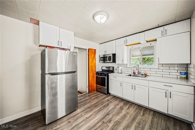 23701 Colbourne Rd, Euclid, OH 44123 - kitchen with stainless steel appliances, a sink, white cabinets, and dark wood-style flooring
