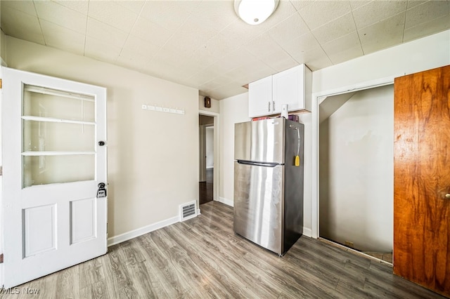 23701 Colbourne Rd, Euclid, OH 44123 - kitchen with freestanding refrigerator, wood finished floors, and white cabinetry