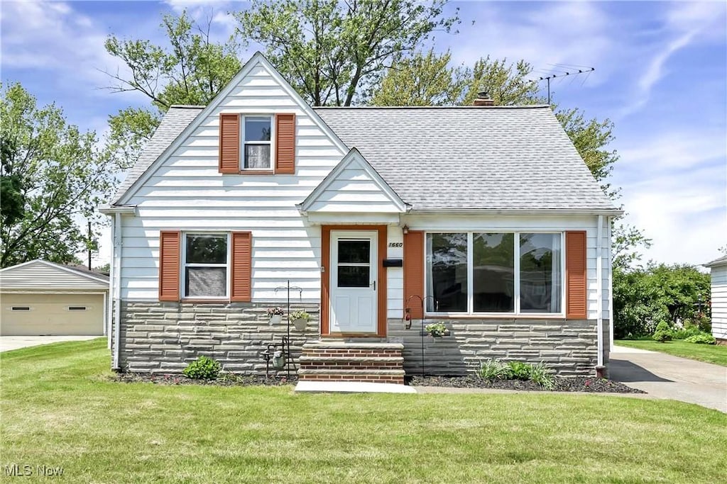 1660 Ridgeview Dr, Wickliffe, OH 44092 - bungalow with stone siding, a shingled roof, a front lawn, and a garage