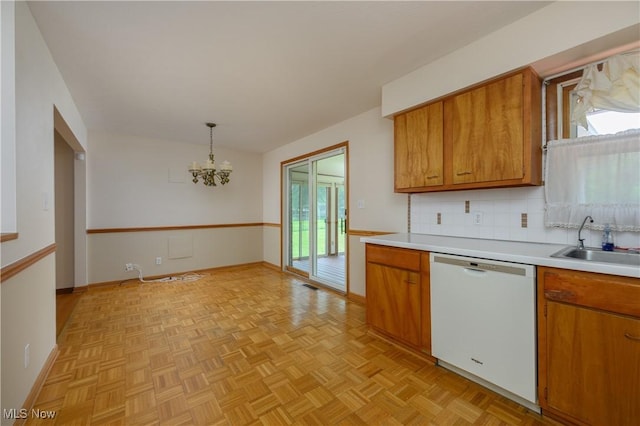 1214 Highwood Dr, New Franklin, OH 44216 - kitchen with white dishwasher, a sink, brown cabinetry, and a chandelier