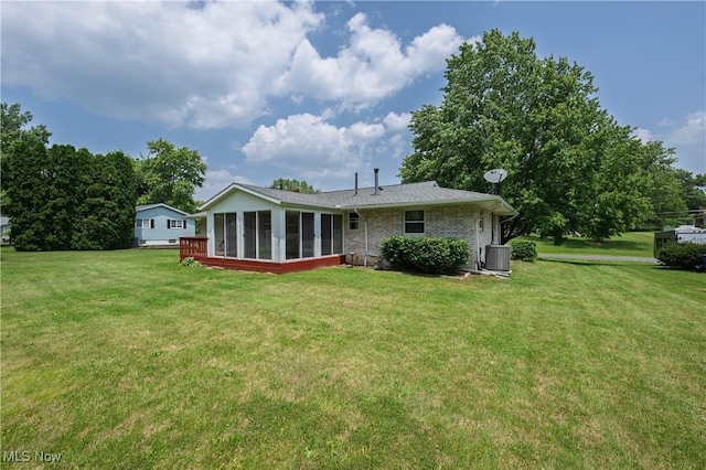 1214 Highwood Dr, New Franklin, OH 44216 - rear view of property with a sunroom, central AC, a yard, and brick siding