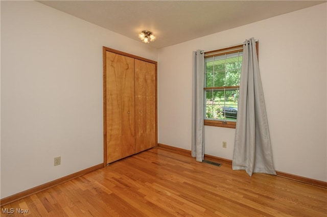1214 Highwood Dr, New Franklin, OH 44216 - unfurnished bedroom with light wood finished floors, baseboards, and a closet