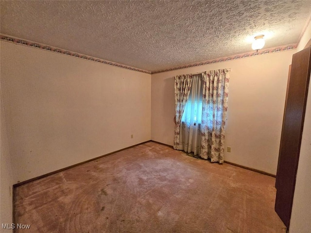 3212 Foxmoor St NE, Hartville, OH 44632 - spare room featuring a textured ceiling, carpet, and baseboards