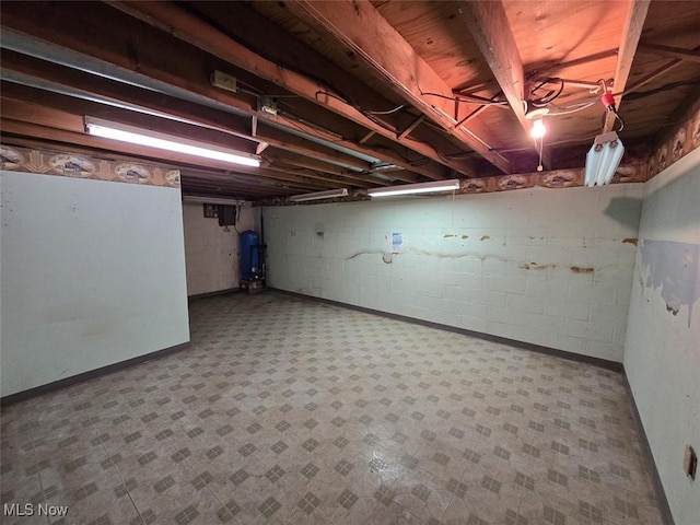3212 Foxmoor St NE, Hartville, OH 44632 - unfinished basement with a water pressure tank, tile patterned floors, concrete block wall, and baseboards